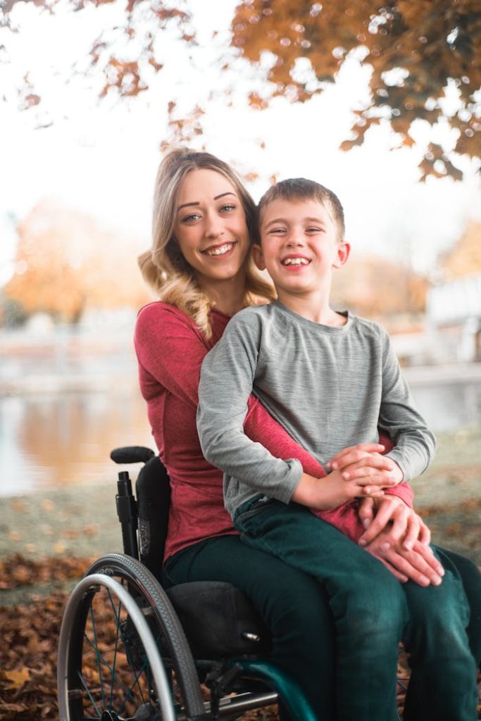 pexels photo 14189512 Happy woman and boy enjoying a moment together by a lake in fall.