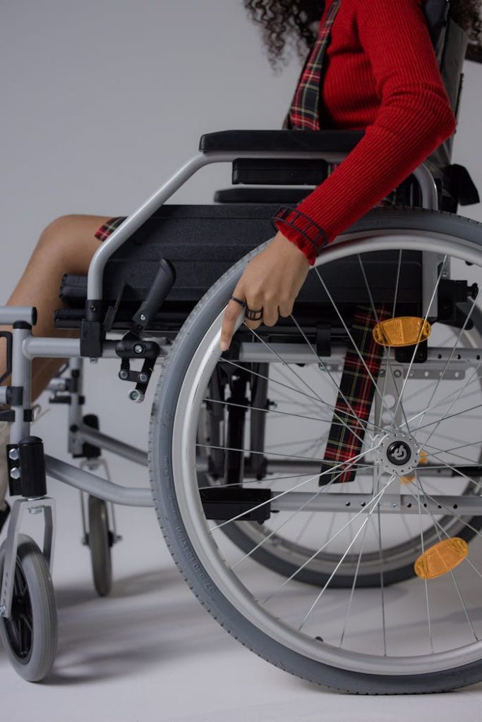 Close-up of a young woman in a wheelchair indoors, highlighting accessibility.